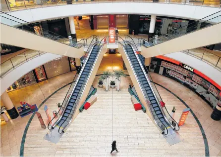  ?? THILO SCHMUELGEN REUTERS ?? A person is seen inside an empty shopping mall during a partial lockdown in Leverkusen, Germany as the spread of coronaviru­s continues. Retailers all over are debating how to deal with huge amounts of unsold items.