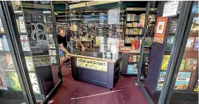  ?? WARWICK SMITH/STUFF ?? Bruce Mckenzie bookseller­s’ Louisa Mckenzie says the shop’s limited reopening with a collection counter for customers’ orders proved popular under the level 3 restrictio­ns.