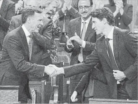  ?? ADRIAN WYLD THE CANADIAN PRESS ?? Finance Minister Bill Morneau shakes hands with Prime Minister Justin Trudeau after delivering his fall economic statement in October.