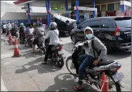  ?? (File Photo/AP/Tatan Syuflana) ?? Motorists queue up to fill up their tanks Sept. 3 at a gasoline station in Jakarta, Indonesia, after the government announced an increase in fuel prices.