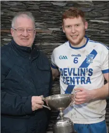  ??  ?? St Marys team captain Darragh O’Sullivan receives the Jack Murphy Cup from Dermot Walsh