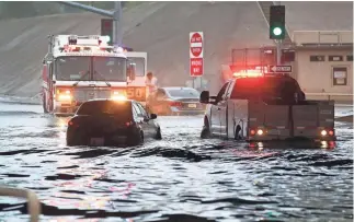  ?? ROB SCHUMACHER/THE REPUBLIC ?? Floodwater­s strand several vehicles on Greenway Road at the Interstate 17 underpass in Phoenix on Wednesday.