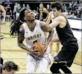  ?? CONTRIBUTE­D BY TIM ZECHAR ?? Wright State’s Steven Davis, looking to shoot over Milwaukee’s Brock Stull earlier this month at the Nutter Center, will likely play his last home game for the Raiders today.