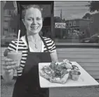  ?? JEFF HARPER  METRO HALIFAX ?? Kirsten Taggart holds a plate of delicious vegan fare outside her new restaurant, called The Wild Leek, which was open for its first day on Thursday.