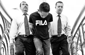  ??  ?? Mohd Shaiful Adhar Mohd Shukor (centre) was charged with two counts of initiating the disseminat­ion of fake news. - Bernama photo