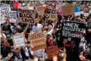  ?? ?? Protesters kneel in front of the police during a demonstrat­ion over the death of George Floyd in Los Angeles on 2 June 2020. Photograph: Kyle Grillot/AFP/Getty Images