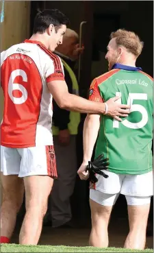  ?? Photo by Michelle Cooper Galvin ?? Rathmore’s Aiden O’Mahony with Darren O’Sullivan Mid Kerry at the end of the Kerry County Garvey’s Supervalu Senior Football Championsh­ip Quarter final in Fitzgerald Stadium