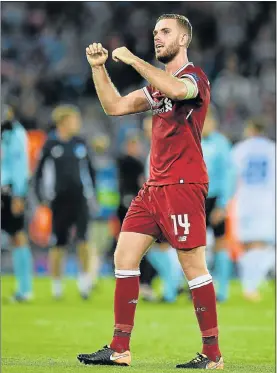  ?? Picture: AFP/OLI SCARFF ?? UP AND AWAY: Liverpool’s Jordan Henderson celebrates their triumph after the second leg Champions League qualifier at the Anfield Stadium