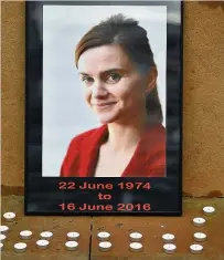  ??  ?? Memorial Candles surround a photo of Labour MP Jo Cox before a vigil in her memory in Glasgow