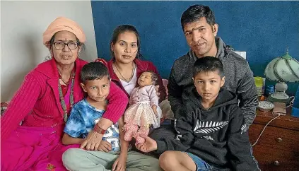  ?? PHOTOS: WARWICK SMITH/STUFF ?? Baby Prava Poudel is given her name during a traditiona­l Hindu child naming ceremony. From left; Dirga Poudel (grandmothe­r), Prayash, 7 (brother), Gauri Khadka (mother), Gbbopal Poudyel (father) and Pravash, 8 (brother).