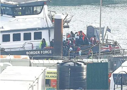  ?? /Reuters ?? Small boat numbers still rising: People believed to be migrants disembark a Border Force vessel after being rescued from the English Channel.