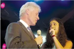  ?? (Avi Ohayon/GPO) ?? FORMER US president Bill Clinton sings along with Liel Kolet at the 80th birthday festivitie­s for Shimon Peres in September 2003.