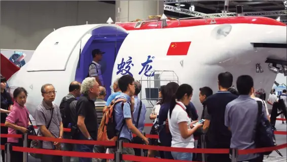  ?? ZHENG / CHINA DAILY PHOTOS BY PARKER ?? Visitors stand in line to get into a Chinese manned deep-sea research submersibl­e, to learn more about the developmen­t of the country’s deep-sea diving technology.