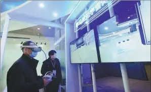  ?? LONG WEI / FOR CHINA DAILY ?? Visitors experience KPMG’s metaverse booth at the Global Digital Trade Expo in Hangzhou, Zhejiang province, in December 2022.