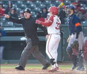  ?? NWA Democrat-Gazette/ANDY SHUPE ?? Plate umpire Chris Coskey (left) signals a balk to score an Arkansas run as catcher Grant Koch (33) stands in against Bucknell on Friday at Baum Stadium.