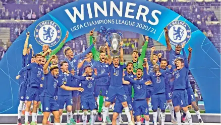  ?? — AP ?? Chelsea players celebrate with the trophy after winning the Champions League on Saturday. They beat Manchester City 1-0 in the final.