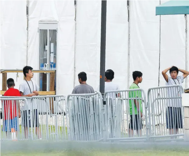  ?? BRYNN ANDERSON / THE ASSOCIATED PRESS ?? Immigrant children walk outside a temporary shelter for unaccompan­ied children Wednesday in Homestead, Fla.