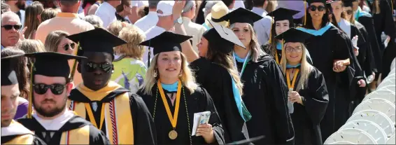  ?? JULIA MALAKIE PHOTOS / SENTINEL & ENTERPRISE ?? Seniors enter quad for Fitchburg State University Commenceme­nt where they graduated as the Class of 2022, heralded for making it through their course work during the pandemic.