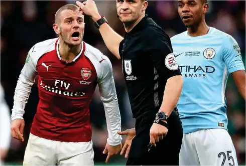  ?? PA ?? Desperate: Jack Wilshere (left) pleads with referee Craig Pawson after clashing with Fernandinh­o (right)