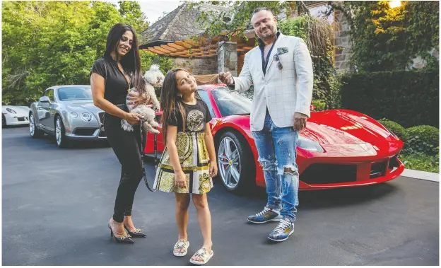  ?? NICK KOZAK FOR POSTMEDIA ?? Rita Kilislian, Andy Curnew and their seven-year-old daughter Alexa stand with their dog Chanel in front of their Bridle Path home in Toronto.