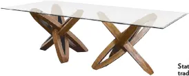  ?? ?? Biara’s Estrella dining table gets its name from the Spanish word for “star,” which its hand-carved Philippine mahogany base represents, topped by tempered glass.