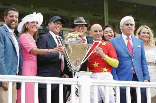  ?? BARBARA D. LIVINGSTON ?? From left: Part-owners Sol Kumin, Lisa and Kenny Troutt, and Teo Ah Khin celebrate Justify’s Triple Crown victory at Belmont Park along with jockey Mike Smith and Bob and Jill Baffert.