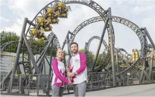  ?? Photo: VCG ?? Marnie Woolrich ( left), 19, and Justin Mould, 35, from Newcastle- underLyme participat­e in the Queen’s Baton Relay at Alton Towers Resort in Staffordsh­ire, England on July 19, 2022, ahead of the 2022 Birmingham Commonweal­th Games, which will kick off next week.