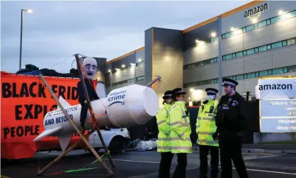  ?? Photograph: Henry Nicholls/Reuters ?? An Extinction Rebellion protest outside Amazon a fulfilment centre in Tilbury on Black Friday – one of the busiest shopping days of the year.