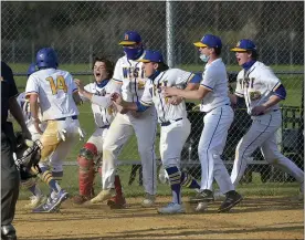  ?? PETE BANNAN — MEDIANEWS GROUP ?? Downingtow­n West players congratula­te Greyson Kovatch after he scored the winning run on a passed ball to send the Whippets to a 5-4comeback victory Monday evening over West Chester Henderson.