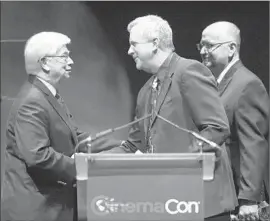  ?? Michael Buckner
Getty Images for CinemaCon ?? CHRIS DODD, left, chairman of the Motion Picture Assn. of America, greets Bill Campbell, president of Orpheum Theatre Inc., and John Fithian, president of the National Assn. of Theatre Owners, onstage at CinemaCon in Las Vegas.