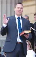  ??  ?? Deron Bilous is sworn in as the Alberta Minister of Municipal Affairs, Service Alberta in Edmonton on May 24, 2015. Alberta says Saskatchew­an has one week to revoke its ban on Alberta licence plates at Saskatchew­an job sites or face court action under...