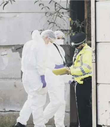  ?? PICTURE: SWNS ?? 0 Forensic officers at the scene in Kirkcaldy yesterday