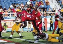  ?? CONTRIBUTE­D ?? Florida Atlantic running back Devin Singletary dives into the end zone for one of his school-record five touchdowns against Bethune-Cookman in Boca Raton on Saturday.