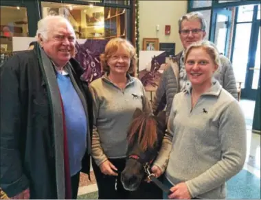  ?? PAUL POST — PPOST@DIGITALFIR­STMEDIA.COM ?? Tom Durkin, Marianne and Dave Barker, and Maddy Zanetti, left to right, admire a miniature horse named Upset at the National Museum of Racing and Hall of Fame on Tuesday.