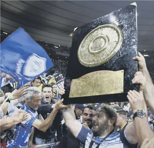  ?? PICTURE: CHRISTOPHE SIMON/AFP/GETTY ?? 0 Prop Daniel Kotze holds the Bouclier de Brennus trophy as he celebrates Castres’ victory.