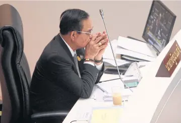  ?? WICHAN CHAROENKIA­TPAKUL ?? Prime Minister Prayut Chan-o-cha appears in a pensive mood as the opposition singles him out in the censure debate which entered its third day yesterday.