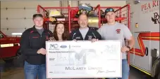  ?? TIMES photograph by Annette Beard ?? Jessica Hudson, customer relations with McLarty Daniel, presented a check for $1,700 to Fire Chief Jack Wassman on Monday, March 8. Firefighte­rs Clayton Bass, left, and Quinn Gehler, right, joined in receiving the check presentati­on.