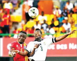  ?? JUSTIN TALLIS/AFP ?? Ghana’s Asamoah Gyan (right) heads the ball with Uganda’s Tony Mawejje during the 2017 Africa Cup of Nations group D match in Port-Gentil on January 17, 2017.