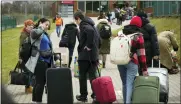  ?? SERGEI GRITS — THE ASSOCIATED PRESS ?? People return back to Ukraine at the border crossing in Medyka, southeaste­rn Poland, Saturday.