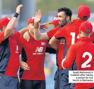  ??  ?? Saqib Mahmood is mobbed after taking a wicket for the North in Barbados