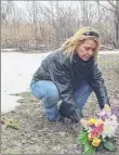  ??  ?? Conway Beach places flowers at the location where she found her sister's body in a scene from the documentar­y “Murder on Middle Beach.”