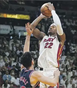  ?? Marta Lavandier Associated Press ?? MIAMI FORWARD Jimmy Butler drives to the basket against Philadelph­ia’s Furkan Korkmaz, another game where the 76ers felt the loss of Joel Embiid.