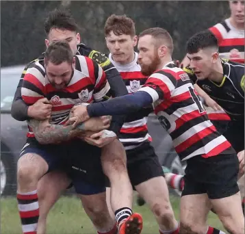  ??  ?? Enniscorth­y’s Angelo Todisco driving forward with help from Hugh O’Neill in their home win against Kilkenny on Saturday that secured the Leinster League Division 1A title.