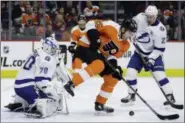  ?? MATT SLOCUM — THE ASSOCIATED PRESS ?? Tampa Bay Lightning’s Louis Domingue (70) blocks a shot as Philadelph­ia Flyers’ James van Riemsdyk (25) and Lightning’s Ryan McDonagh (27) look for the rebound during the second period of an NHL hockey game, Tuesday, Feb. 19, 2019, in Philadelph­ia.