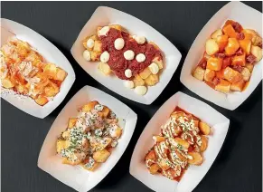  ?? SUPPLIED ?? Fried potatoes come with various toppings at Mercado Little Spain. If you’re in a group, you’ll be able to try them all.