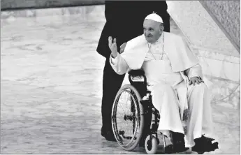 ?? TARANTINO AP PHOTO/ALESSANDRA ?? Pope Francis arrives in a wheelchair to attend an audience with nuns and religious superiors in the Paul VI Hall at The Vatican, on May 5.