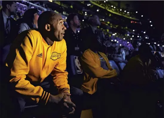  ?? KOBE BRYANT WATCHES Wally Skalij Los Angeles Times ?? a tribute video during his retirement ceremony at Staples Center in April 2016. Bryant was killed in a helicopter crash on Jan. 26.