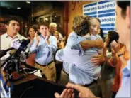  ?? WADE SPEES/THE POST AND COURIER VIA AP ?? U.S. Rep. Mark Sanford hugged his sons after addressing his supporters at Liberty Tap Room in Mount Pleasant, S.C., Tuesday. Sanford lost his first election ever Tuesday, beaten for the Republican nomination for another term in the coastal 1st District...