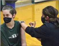  ?? MEDIANEWS GROUP FILE PHOTO ?? Ridley school nurse RN Gina Capozzoli gives sophomore Erin Charitonch­ick the Pfizer COVID vaccine at Ridley High School last spring.