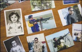  ??  ?? Photograph­s of al-Sudani are laid out at his family’s home in Baghdad.